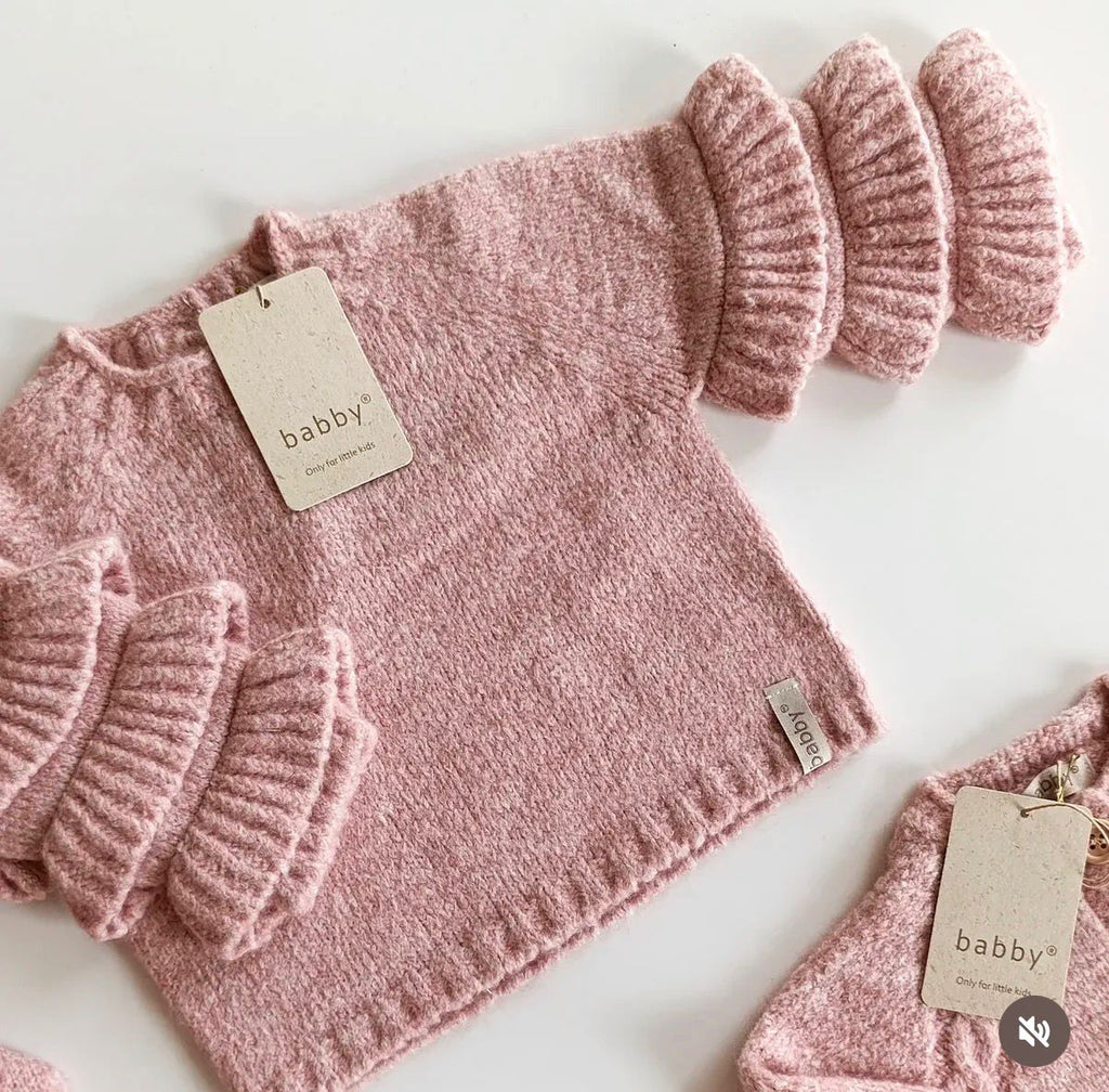 Sueter con volante rosa en punto